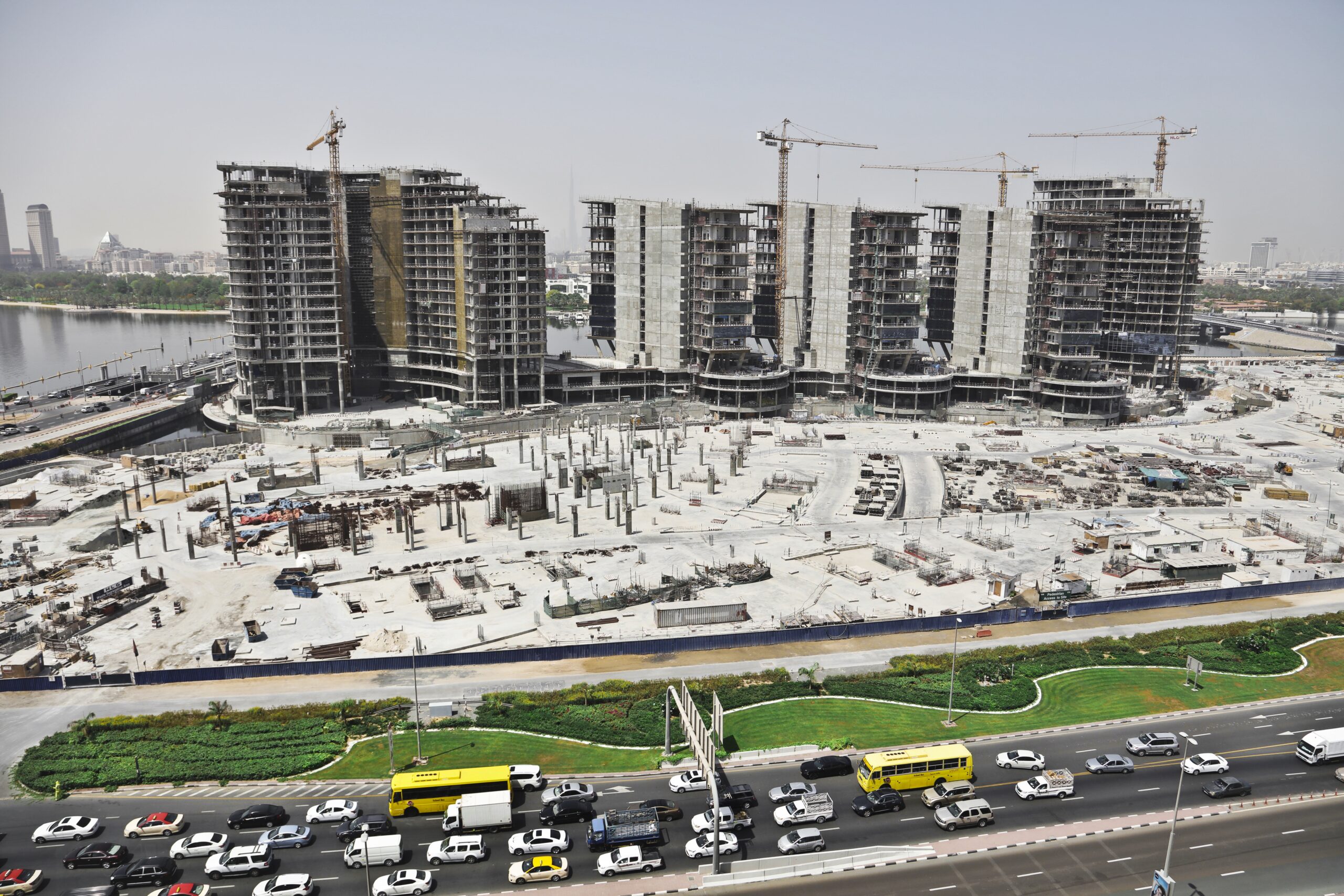A distant shot of an urban area with cars on the street and high buildings